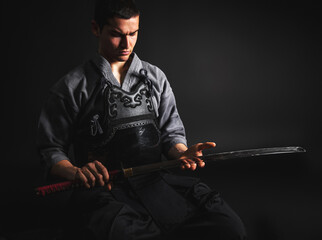 Portrait of Kendo master sitting and preparing for fight.
