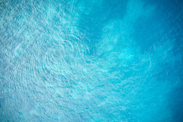 A whirlpool on the turquoise sea surface. Shooting from the air. Copy space.
