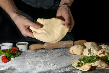 The cook prepares pasties. Step-by-step instruction. Forms the dough. Wooden background.