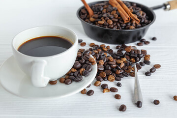 Fototapeta na wymiar coffee cup and coffee bean on white wooden table