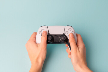 Videogame console wireless gamepad. Blue background. Minimal style. Modern leisure at home.  © troyanphoto