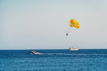 yellow parasailing over the sea