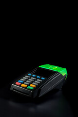 Contactless terminal on black background. Bank card paying terminal.