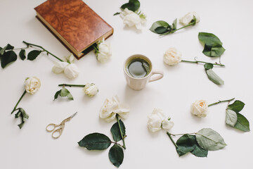 Beautiful composition with cup of matcha tea and flowers on white background. Flatlay, top view