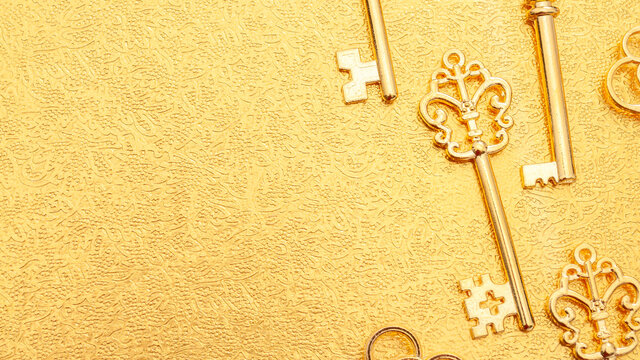 Secret wealth and the key to success concept with pattern of many ornate gold skeleton keys isolated on golden background with copy space