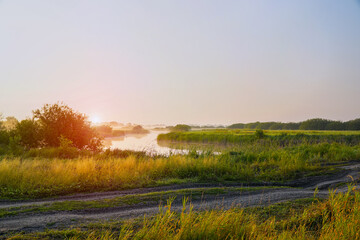 Obraz premium Sunrise in a light fog on a small river