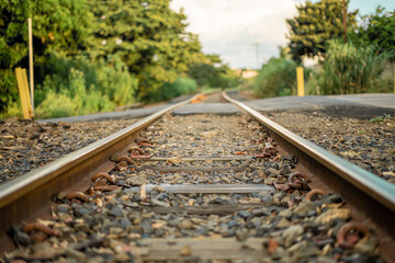Naklejka premium Railroad crossing and blue sky, late afternoon. Close up.