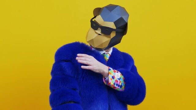Man wearing funny masks and doing party. Celebrating and dancing over colored backgrounds