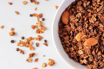 Homemade granola in a white plate, top view. Healthy food concept. 
