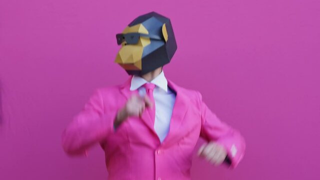Man wearing funny masks and doing party. Celebrating and dancing over colored backgrounds