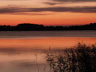 beautilful sunset with clouds and grass baltic sea