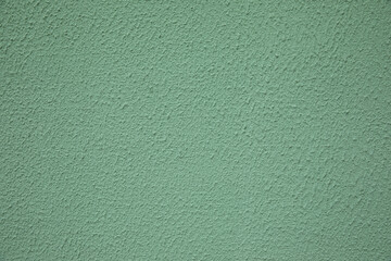 Green stone background from green plaster on the street