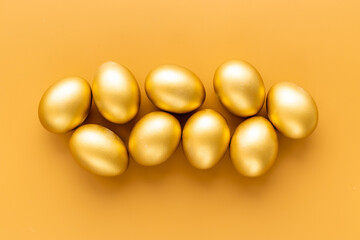 Golden eggs flat lay. Save money. Wealth and good luck symbol