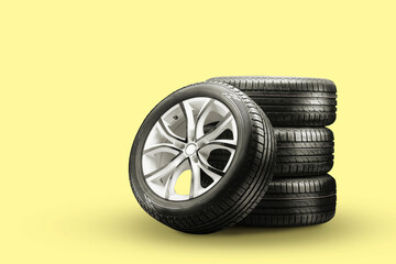 summer tires and wheels-stack on a yellow background, new wheels