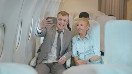 Happy Adult Caucasian passengers is making selfie or Video call onboard , travel vacation and transportation concept..