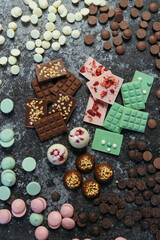 Fototapeta na wymiar Belgian chocolate. Assortment of chocolates, white, dark and milk chocolate Sweets background. Copy space.