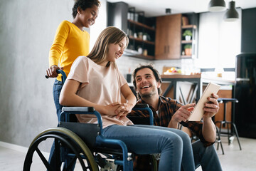 Happy multiethnic family with child with disability in wheelchair