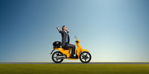 happy businessman or office worker riding on yellow scooter