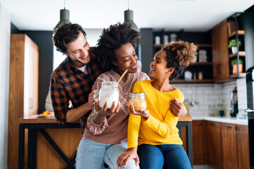 Multi ethnic family in love together in kitchen