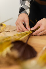 florist makes beautiful bouquet of dried flowers