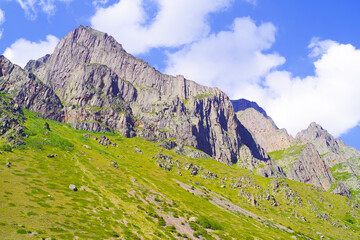 Rocks on the green hills of the Chegem gorge