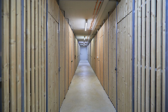 Cellar compartment in a residential building. The compartments are closed with wooden doors. 