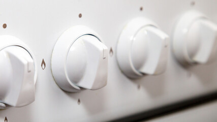 Gas adjustment knob on a kitchen stove, close-up.