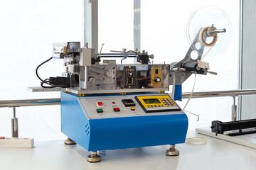 professional table equipment in factory, blue china elastic tape cold or hot cutting machine, satin...