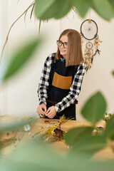 Florist makes beautiful bouquet of dried flowers