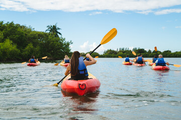 Girl Kayaking with a group of Friends