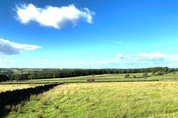 Extensive landscape, with dry stone walls, fields, a tractor, and distant hills, near, Timble, Harrogate, UK