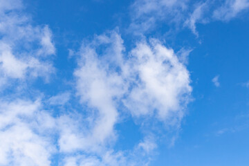 Detail of a white cloud in a bright blue sky. 
Dark rain clouds displace the blue sky. Storm is coming. Cumulus clouds on a sunny Day. 