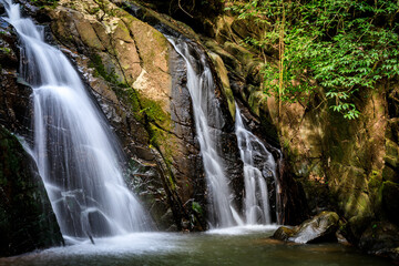 waterfall in the forest or motion of water at brook of water fall. with tree leaf and stone rock. at Spun or Span Nan province, Thailand, Asia.