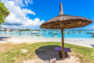 Parasol de paille sur plage de Grand-Baie, île Maurice 