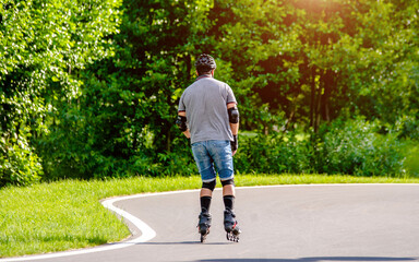 man roller skating in the summer Park
