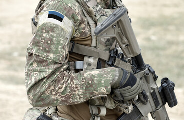 Soldier with assault rifle and flag of Estonia on military uniform. Collage.