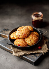 Cottage cheese pancakes. Syrniki with jam on grey background