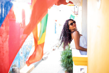 Beautiful local Colombian woman in white dress in the walled city of Cartagena, Colombia