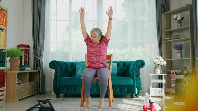 Senior woman Sit on chair to exercise shoulders and arms