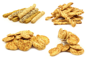 bunch of cheese pretzels and some in a glass bowl on a white background