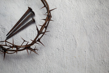 Crown of thorns with three nails on grey background. Easter concept.