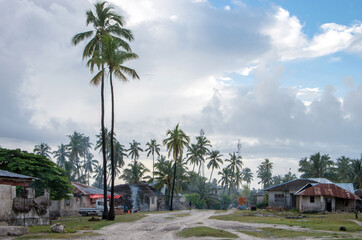 Fototapeta premium View of a typical African village in East Africa. Weekday on the street in a village.