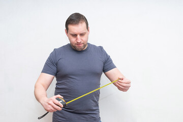 a man with a centimeter on a white background