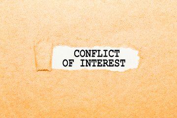 text CONFLICT OF INTEREST on a torn piece of paper, business concept
