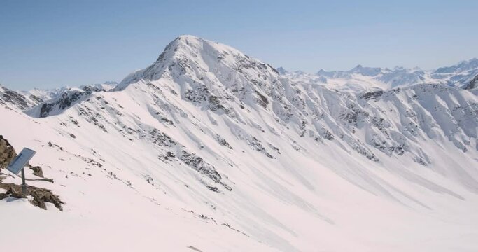 Winter panorama in the Swiss Alps, as seen from Parpaner Rothorn mountain peak in Arosa - Lenzerheide ski resort, pan right.
