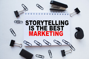 Notepad with inscriptions STORYTELLING IS THE BEST MARKETING on a white background. business concept.