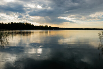 Sunset sky with rain cloud on the lake.