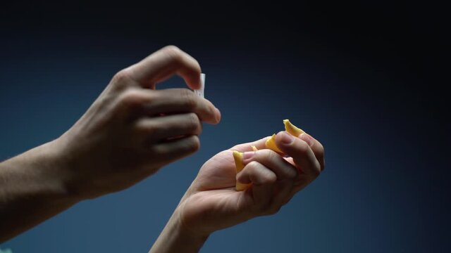 Man's hand open fortune cookie with note