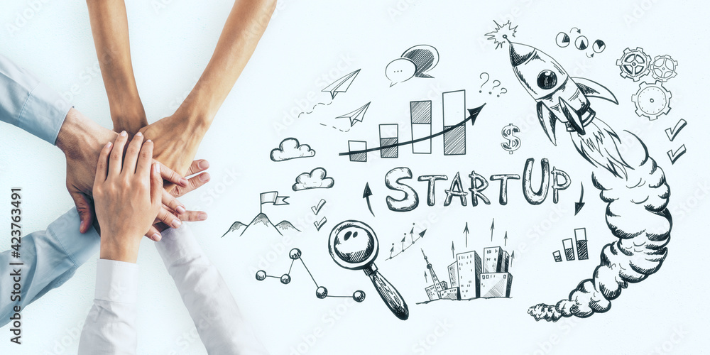 Aufkleber Start up concept with hands in a pile on light surface and sketch of rocket, loupe and graphs.