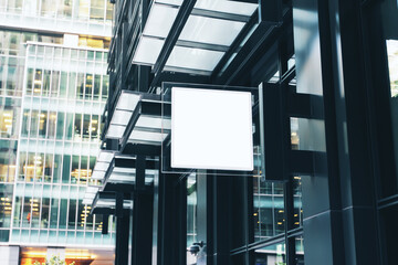 White square sign with blank space for your logo on the wall of a modern shopping mall, mock up